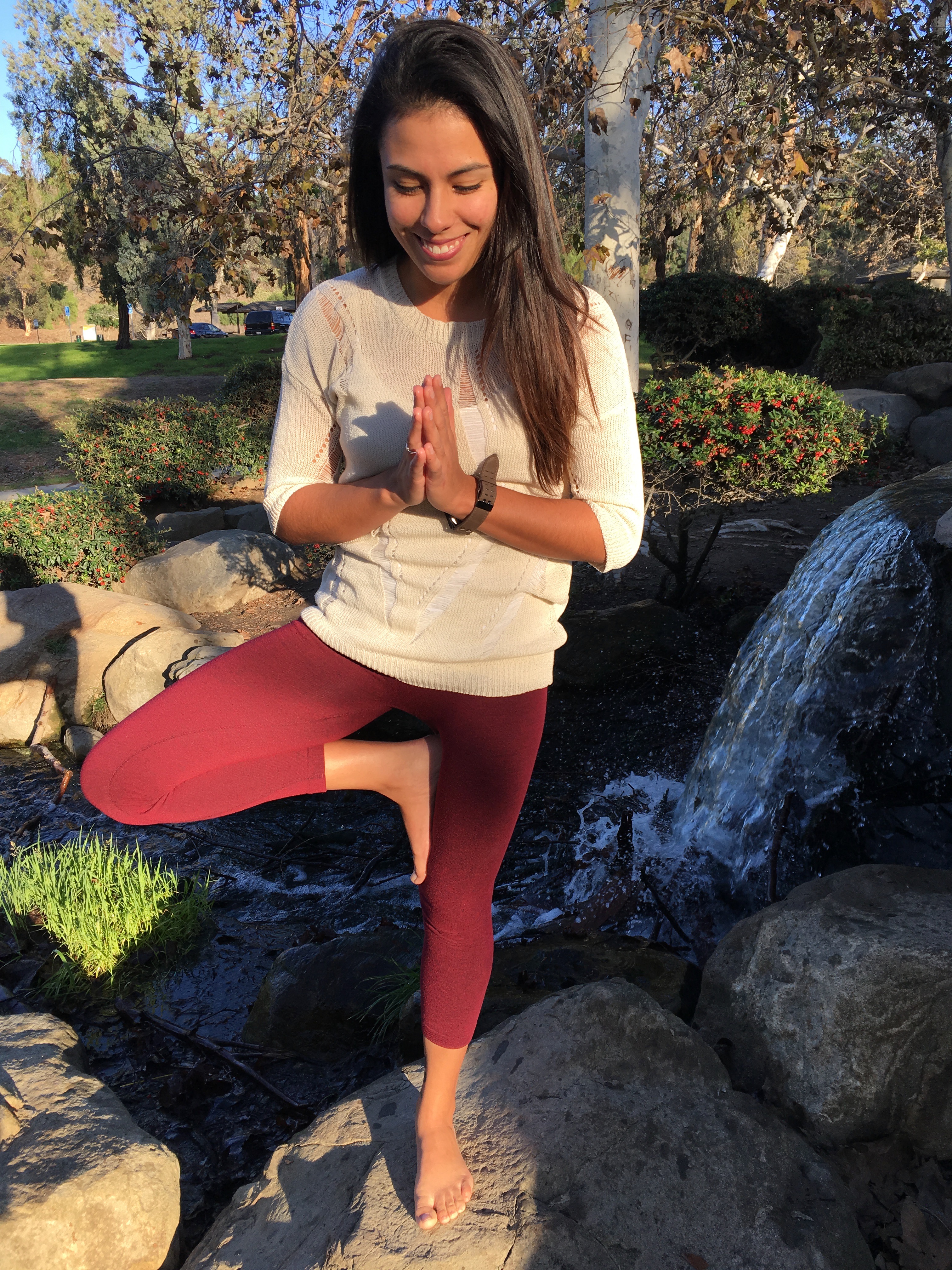 Woman in yoga pose lightheartedly glancing down